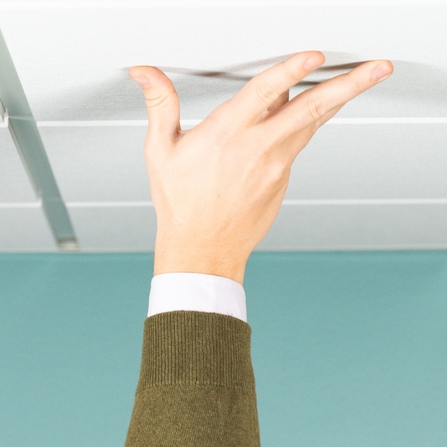 Hands Touching Acoustic Ceiling Tiles